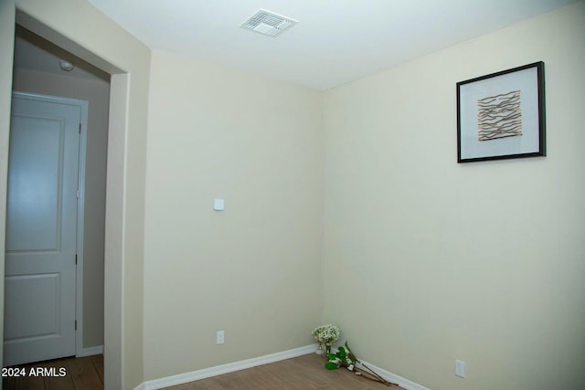 unfurnished room with hardwood / wood-style flooring