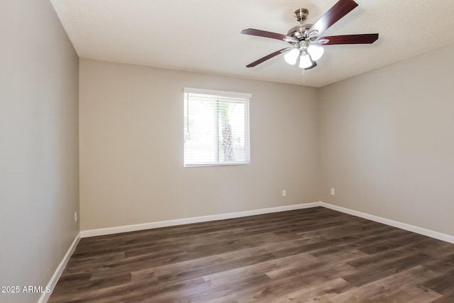 unfurnished room with dark wood finished floors, baseboards, and ceiling fan