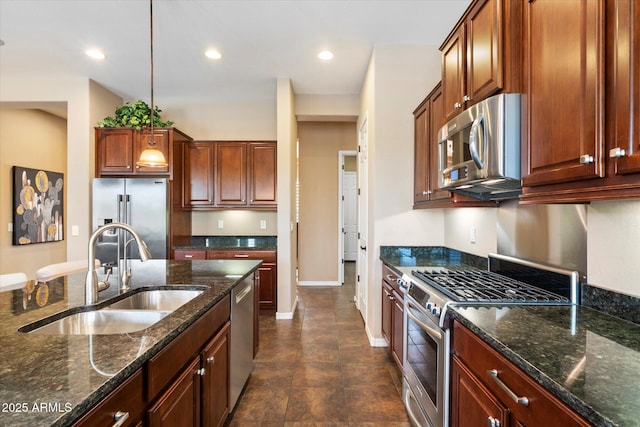 kitchen featuring a sink, appliances with stainless steel finishes, recessed lighting, and dark stone counters