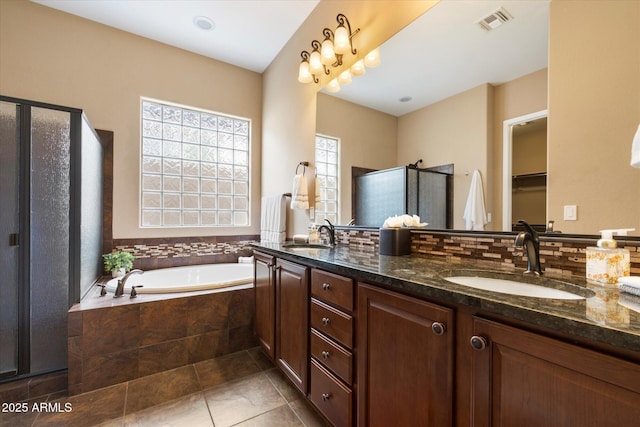 full bath with visible vents, a shower stall, a sink, and a bath