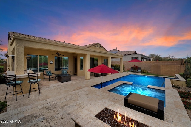 view of swimming pool featuring a fenced in pool, a fenced backyard, an in ground hot tub, a ceiling fan, and a patio