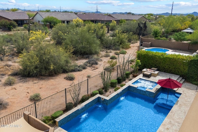 view of pool featuring a fenced in pool, a fenced backyard, a mountain view, an in ground hot tub, and a patio