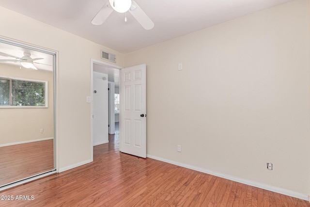 8738 E Vista Dr, Scottsdale, AZ 85250 - unfurnished bedroom featuring light wood-style floors, multiple windows, and ceiling fan