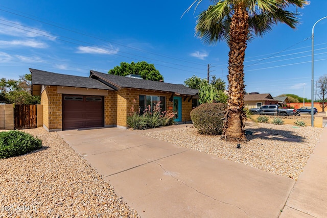 8738 E Vista Dr, Scottsdale, AZ 85250 - ranch-style home with brick siding, an attached garage, concrete driveway, and a shingled roof