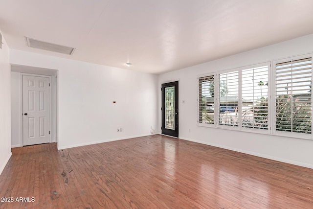 8738 E Vista Dr, Scottsdale, AZ 85250 - spare room featuring wood finished floors and attic access