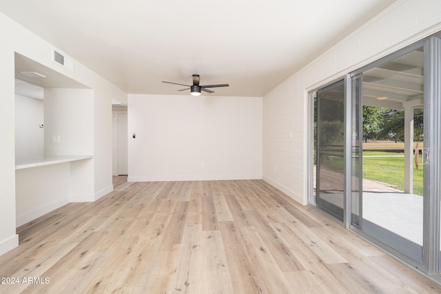 empty room featuring ceiling fan and light wood-type flooring