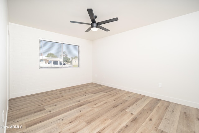 unfurnished room with ceiling fan and light wood-type flooring