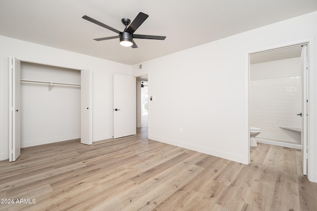 unfurnished bedroom featuring ceiling fan, connected bathroom, a closet, and light wood-type flooring