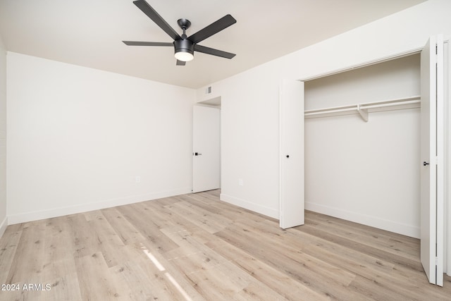 unfurnished bedroom featuring light hardwood / wood-style floors, ceiling fan, and a closet