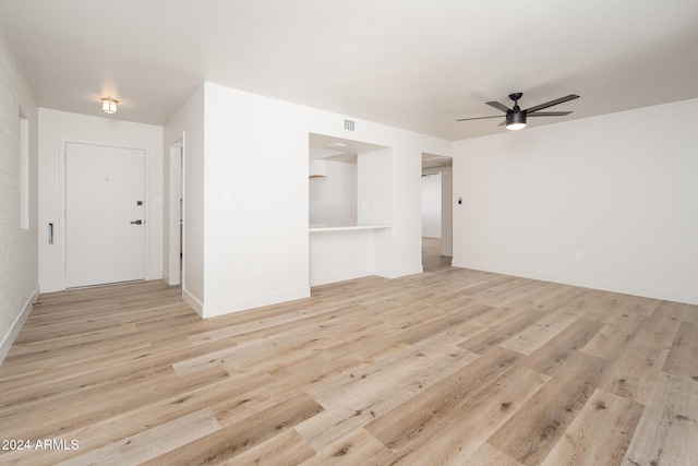 unfurnished living room featuring ceiling fan and light wood-type flooring