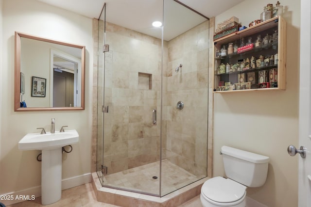 bathroom with toilet, walk in shower, and tile patterned flooring