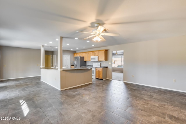 kitchen with sink, white appliances, ceiling fan, a kitchen island, and light brown cabinetry