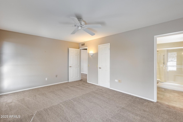 unfurnished bedroom featuring ceiling fan, ensuite bathroom, and carpet floors