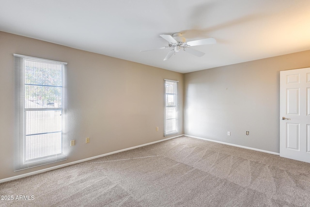 carpeted spare room with ceiling fan