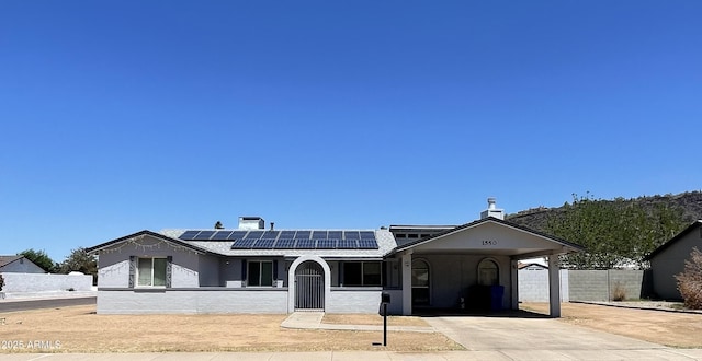 1550 W Willow Ave, Phoenix, AZ 85029 - ranch-style home with solar panels, driveway, a carport, and stucco siding