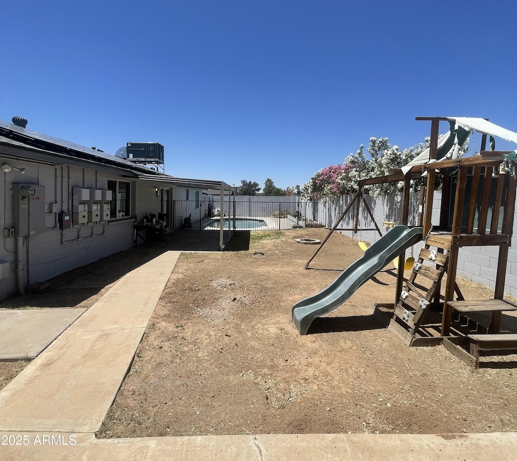 1550 W Willow Ave, Phoenix, AZ 85029 - view of play area featuring central AC and a fenced backyard