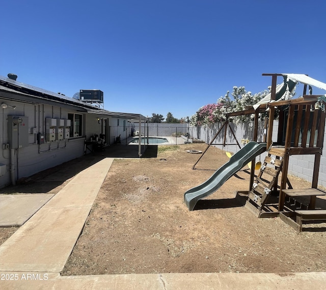 1550 W Willow Ave, Phoenix, AZ 85029 - view of play area featuring central AC and a fenced backyard