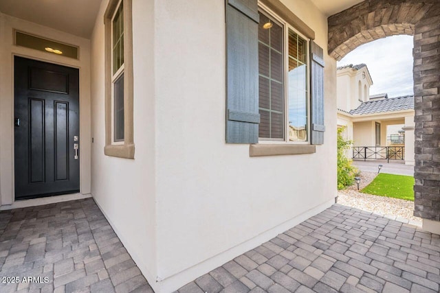 property entrance featuring stucco siding