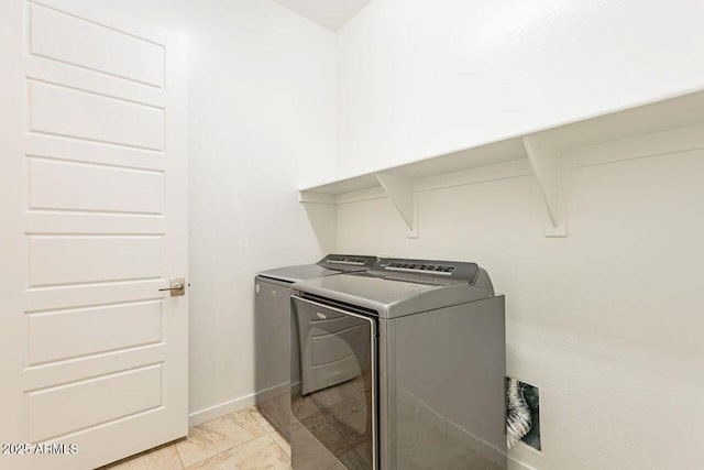 laundry area featuring laundry area, washer and dryer, and baseboards