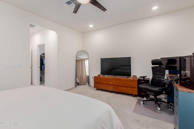 bedroom with light colored carpet, a desk, recessed lighting, ceiling fan, and a spacious closet