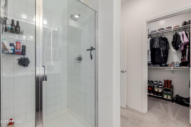 full bathroom featuring a stall shower and a spacious closet