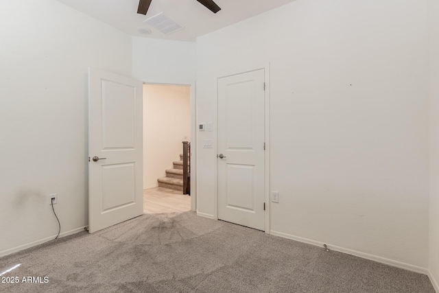 unfurnished bedroom with carpet, baseboards, and a ceiling fan