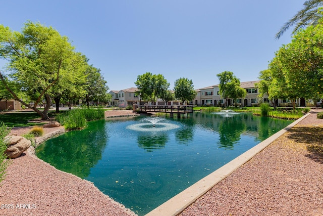 view of swimming pool featuring a water view and a residential view