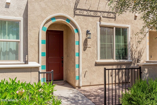 view of exterior entry with stucco siding
