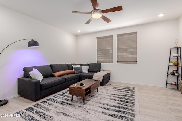 living area featuring a ceiling fan, recessed lighting, light wood-style flooring, and baseboards