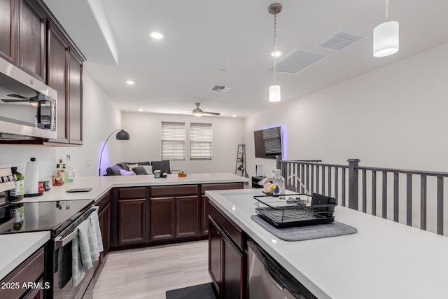 kitchen featuring appliances with stainless steel finishes, light countertops, ceiling fan, dark brown cabinets, and recessed lighting