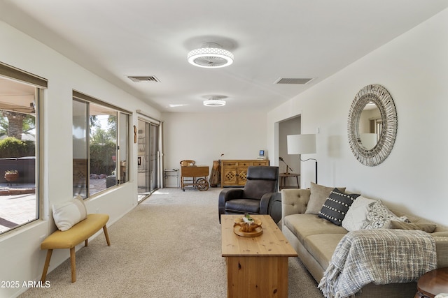 living room featuring light colored carpet and visible vents