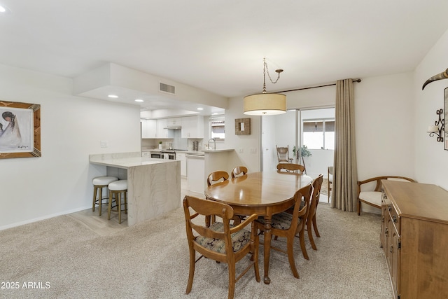 dining space with light colored carpet, visible vents, recessed lighting, and baseboards
