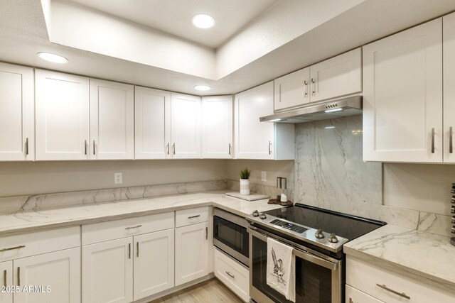 kitchen with white cabinets, stainless steel appliances, and under cabinet range hood