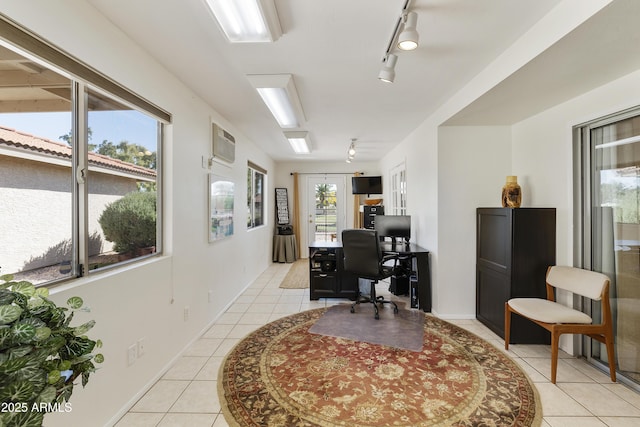 office featuring baseboards, track lighting, an AC wall unit, and light tile patterned floors