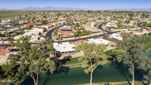 drone / aerial view featuring a residential view and a water and mountain view