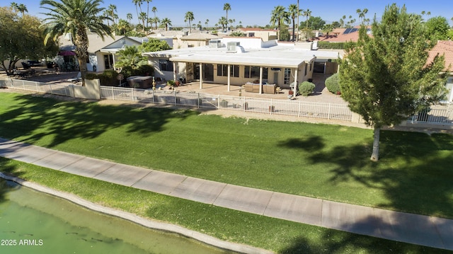 back of house featuring a patio, an outdoor living space, a fenced backyard, and a yard