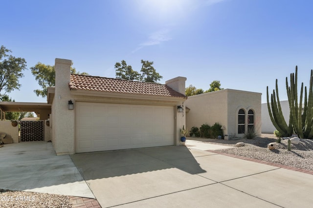 view of front of property featuring driveway, a tile roof, a chimney, stucco siding, and an attached garage