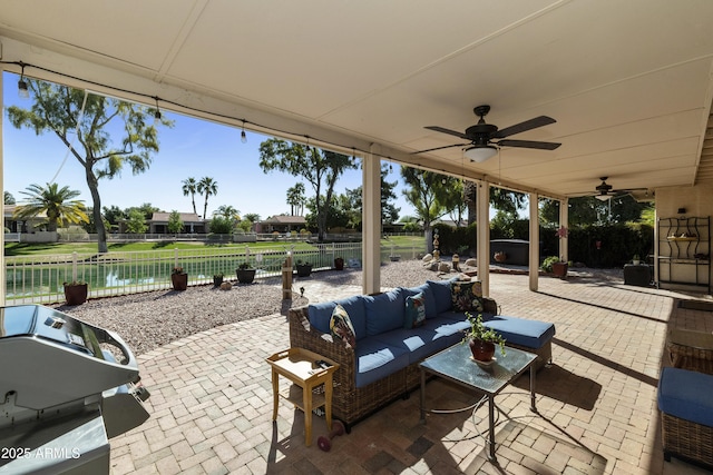 view of patio with outdoor lounge area, a grill, ceiling fan, and a fenced backyard