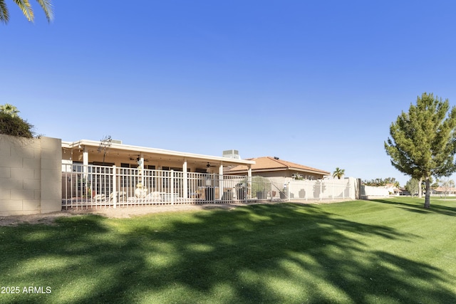 view of yard featuring ceiling fan and fence