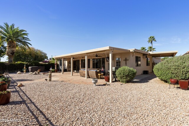 back of property with a patio, outdoor lounge area, and a ceiling fan