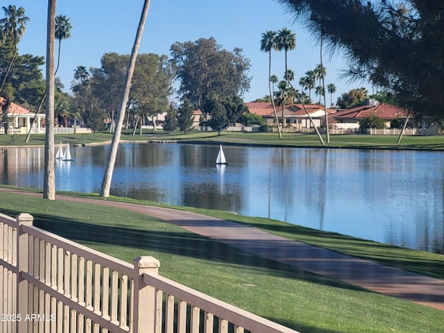 property view of water featuring fence