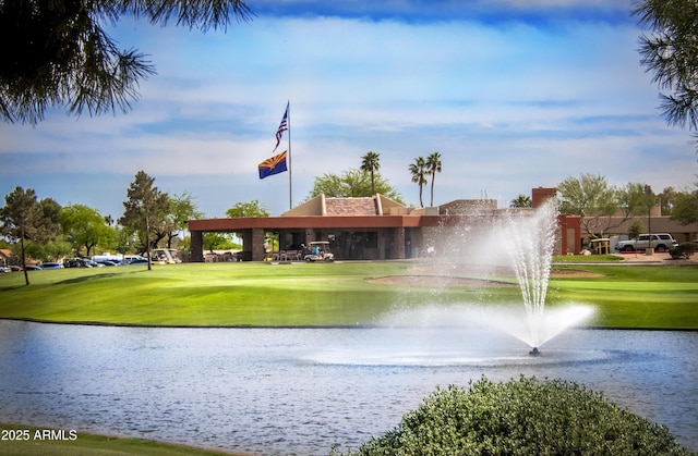 surrounding community with a lawn, a water view, and golf course view