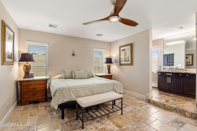 7510 E Larkspur Dr, Scottsdale, AZ 85260 - bedroom featuring stone tile flooring, baseboards, ensuite bathroom, and a ceiling fan