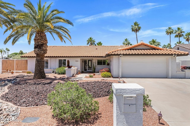 7510 E Larkspur Dr, Scottsdale, AZ 85260 - ranch-style home with stucco siding, an attached garage, driveway, and a tiled roof