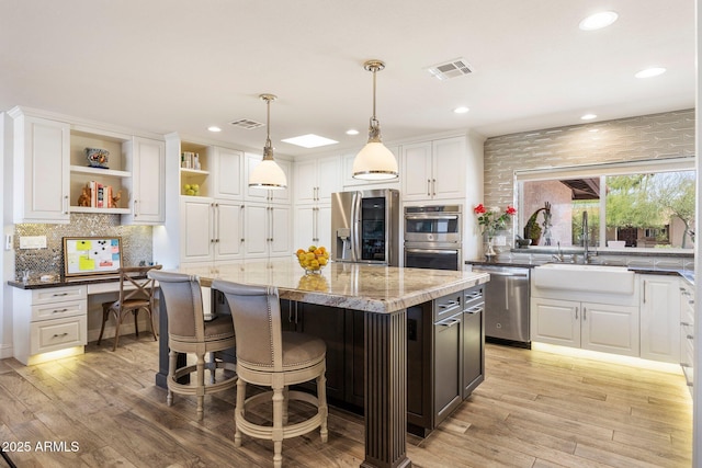 7510 E Larkspur Dr, Scottsdale, AZ 85260 - kitchen featuring appliances with stainless steel finishes, a sink, open shelves, white cabinetry, and recessed lighting