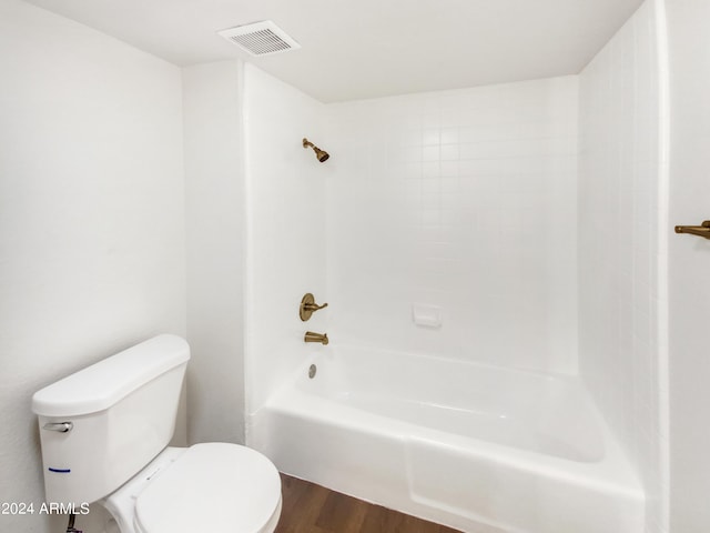 bathroom with hardwood / wood-style flooring, toilet, and shower / bathing tub combination