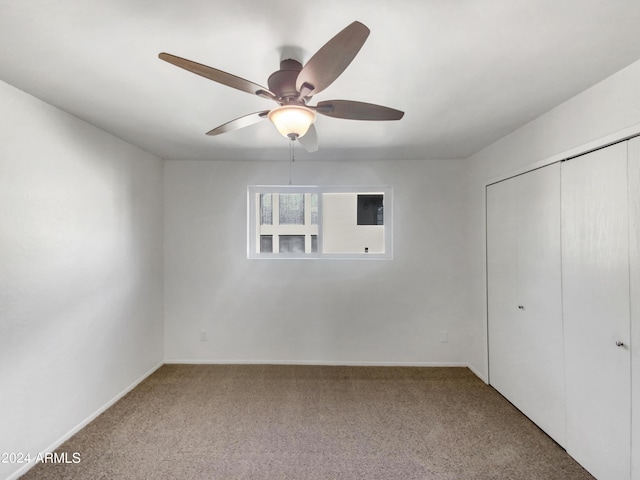 unfurnished bedroom featuring carpet flooring, ceiling fan, and a closet