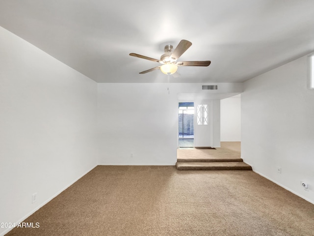 carpeted empty room featuring ceiling fan