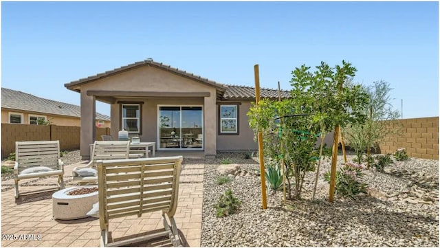 922 W Peralta Pass, Apache Junction, AZ 85120 - rear view of property with a fenced backyard, a patio area, an outdoor fire pit, stucco siding, and a tile roof