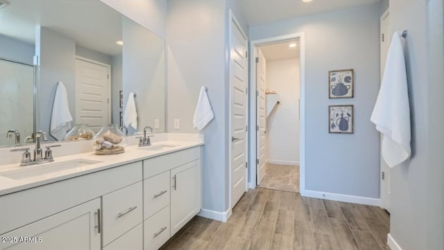 922 W Peralta Pass, Apache Junction, AZ 85120 - bathroom featuring double vanity, wood finished floors, baseboards, recessed lighting, and a closet